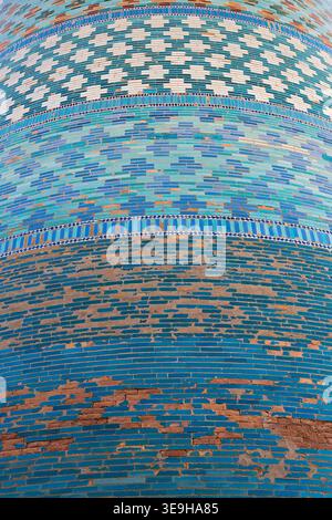 Tiled minaret surface in Ichan Kala old town of Khiva showing geometric patterns in turquoise, white glazed bricks, closeup, details, texture. Ideal f Stock Photo