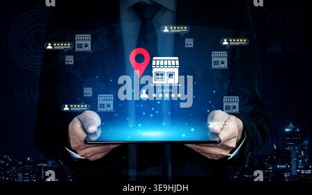 A businessman showcases a tablet displaying a digital map with location pins and ratings, illustrating modern technology impact on customer Stock Photo