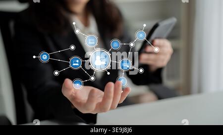 A business professional interacts with a smartphone while showcasing a digital network interface. This visual symbolizes communication, innovation Stock Photo