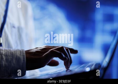Licensed technician writes code on laptop to visualize artificial intelligence neural networks using augmented reality technology, close up. Server hub expert runs AI script for information processing Stock Photo
