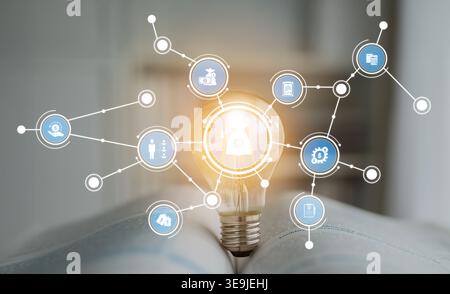 This image features a light bulb surrounded by digital icons, symbolizing innovation and connectivity. It represents ideas, technology, and business Stock Photo