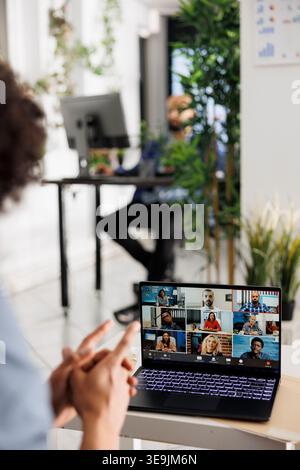 Start up founder having online meeting investors and clients on laptop while working in business office. Company employee using corporate portable computer to telecommute with remote team Stock Photo