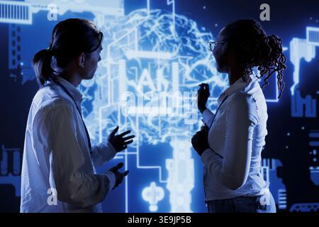 Certified developers brainstorm ways to use AI cognitive computing to extract usable information from complex data. Skilled professionals implement artificial intelligence to process massive datasets Stock Photo