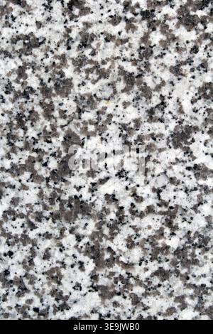 Close-up of a natural grey speckled granite stone texture with black and white mineral grains Stock Photo