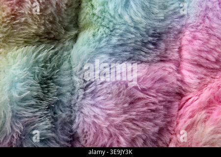 Macro full-frame background of soft, fluffy rainbow faux fur fabric featuring vibrant pastel colours Stock Photo