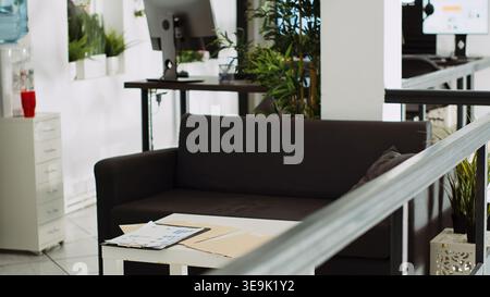 Startup department with workstations, computers at work desks used for company tasks in urban building agency. Empty small business office with stationary and supplies, executive job. Stock Photo