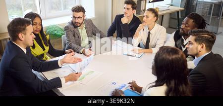 Diverse business team in office meeting discussing strategy and project plans Stock Photo