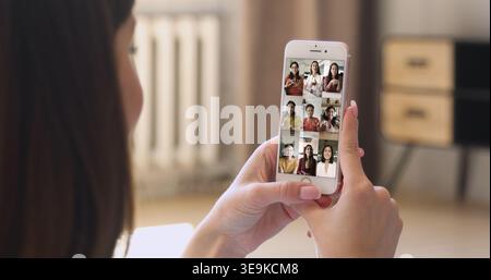Young woman talking on online video conference chat with friends Stock Photo
