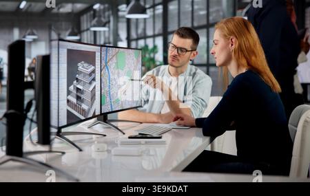 Real Estate Appraiser Woman Reviews Property Maps With Diverse Team Onsite. Stock Photo