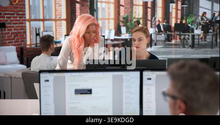 Business Analyst Studies Detailed Risk Reports, Guiding Team Strategy Thoughtfully. Stock Photo