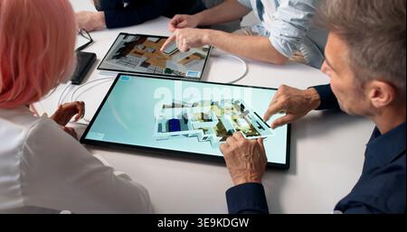 Architects Review 3D Property Remodel On Tablet To Plan New Construction. Stock Photo