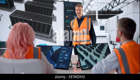 Engineer Leads Team Meeting, Explaining Data Center Infrastructure Build Plan. Stock Photo