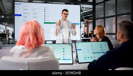 Human Resources Manager Leads Team Meeting Explaining Payroll Software Integration Process. Stock Photo