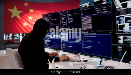 Cybersecurity Expert Coding With Chinese Flag Displayed In Background Stock Photo