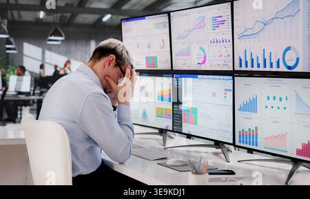 Stressed Business Analyst Struggles With Intricate Data On Computer Screen Stock Photo