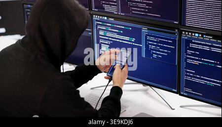 Intruder Injecting Malware Into Smartphone Cybersecurity Threat And Digital Breach Concept Stock Photo