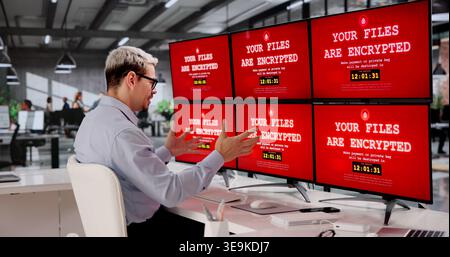 Ransomware Warning. Encrypted Files Displayed On Computer Monitor Amid Cybersecurity Threat, Hacking Risk Stock Photo