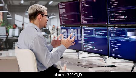 Frustrated Programmer Struggling With Complex Web Development At Office Desk Stock Photo