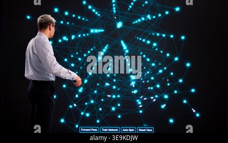 Tech Professional Overseeing AI Model Training On Interactive Display In Modern Office Environment Stock Photo