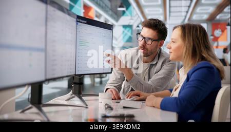 Cybersecurity Specialists Collaborating On Threat Analysis And Risk Management In Corporate Office Stock Photo