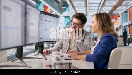 Archivist Diligently Managing Numerous Files On Computer For Cloud-Based Document Solutions Stock Photo