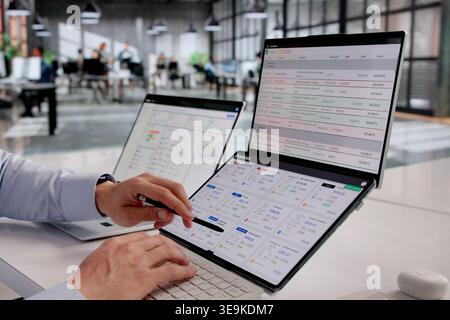 Finance Manager Analyzing Expense Reports With Cutting-Edge Tracking Technology Stock Photo