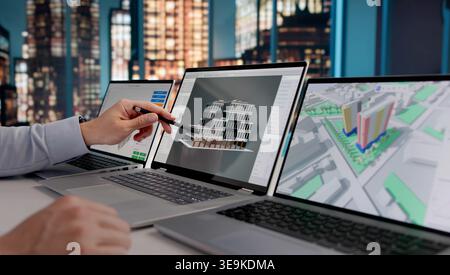 Architect Analyzing 3D BIM Model Designs On Laptop At Night, Engineering And Construction Workflow Stock Photo