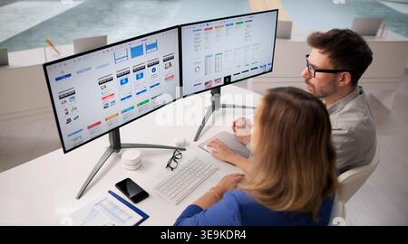 Creative Team Collaborating On User Interface Design At Workspace Using Computers Stock Photo