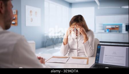 Serious Interview Taking Place In A Critical Disciplinary Meeting Between Medical Professionals Stock Photo