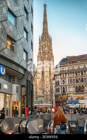 Vienna, Austria - March 5, 2026: St Stephens Cathedral seen from busy shopping street with metro entrance and pedestrians in historic city center. Stock Photo