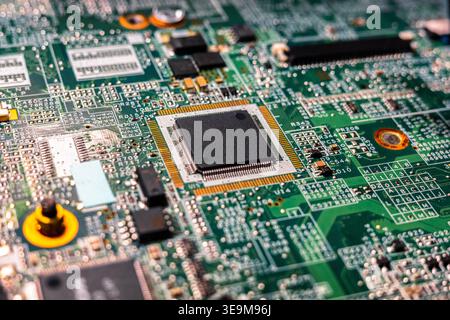 Close up of microchip processor mounted on laptop motherboard with visible circuits and connectors. Detailed macro view highlighting modern electronic Stock Photo