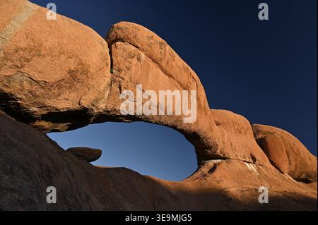 Natural stone arch against blue sky in Spitzkoppe, Namibia Stock Photo