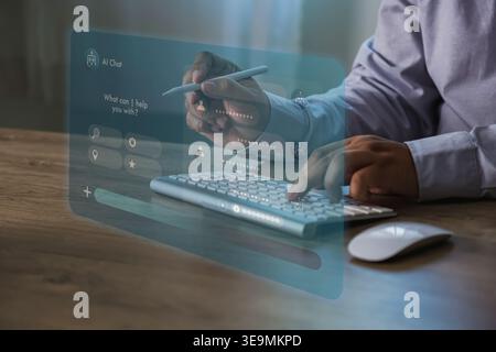 Futuristic chatbot dashboard overlay above hands typing on keyboard and using stylus at workspace, illustrating AI customer support software, automate Stock Photo