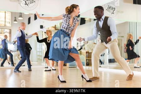 Man and woman performing jazz dance in dancing room Stock Photo