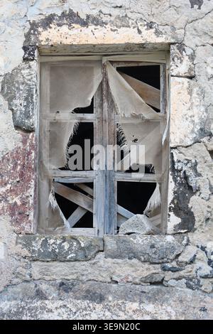 image of a broken wooden window in an old stone building Stock Photo