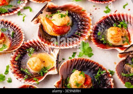 Cooked scallops with parsley on a baking sheet Stock Photo
