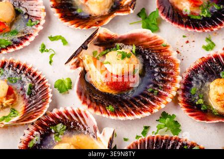 Cooked scallops with parsley on a baking sheet Stock Photo