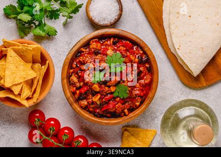 Chili Con Carne in bowl on dark background. Mexican cuisine. Top view Stock Photo