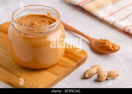 Peanut paste in an open jar Stock Photo