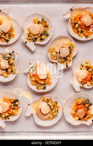 Cooked scallops with sauce on a baking sheet Stock Photo