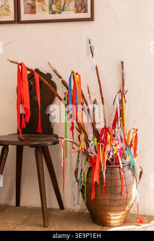 Pottery vase holding traditional pomlazka willow branches decorated with colorful ribbons for Easter Stock Photo