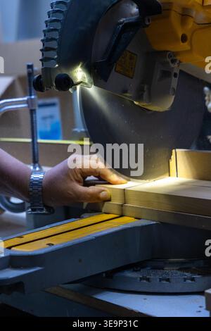 Cutting Wood with Miter Saw in Workshop Close Up Stock Photo