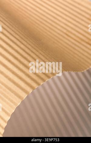 brown corrugated paper sheet with wavy ridges, textured surface with linear pattern, full frame texture, packaging material concept Stock Photo
