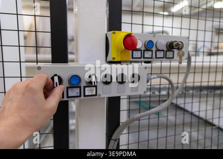 Operator Adjusting Industrial Control Panel in Factory Stock Photo