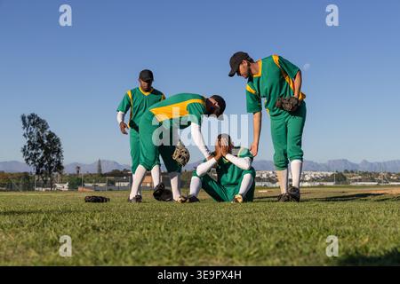 Teammates consoling seated player after error on baseball field, animated hearts around player Stock Photo
