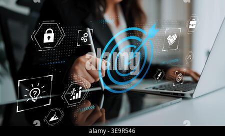 Businesswoman Analyzing Data with Digital Icons and Graphs Focused on Goals, Security, and Strategy in Modern Office Environment Gluon. Stock Photo
