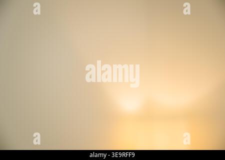 Soft warm gradient bokeh abstract background with golden glow, selective focus Stock Photo