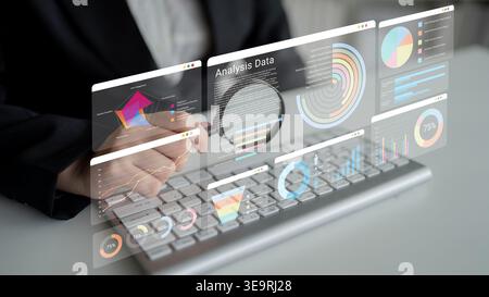 This image showcases a professional analyzing data through interactive graphs and charts on a computer screen, demonstrating modern business analysis Stock Photo