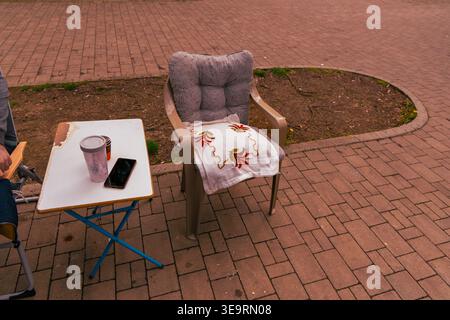 Empty Patio Chair Beside Small Outdoor Table Stock Photo