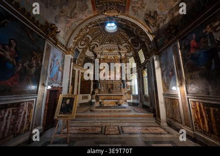 Rome, Italy - Aug 29, 2025: Baroque chapel interior at National Roman Museum Palazzo Altemps, Rome, with frescoed barrel vault, gilded altar, marble f Stock Photo